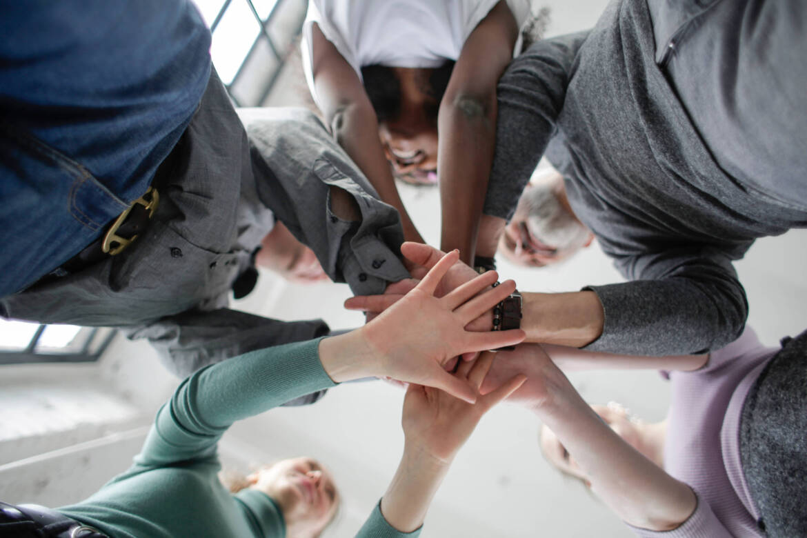 Canva-Low-angle-Photo-of-People-Holding-Hands-Together-scaled.jpg